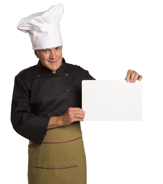 Hombre maduro chef en uniforme pulgares hacia arriba y mostrando la tarjeta de visita en blanco . — Foto de Stock