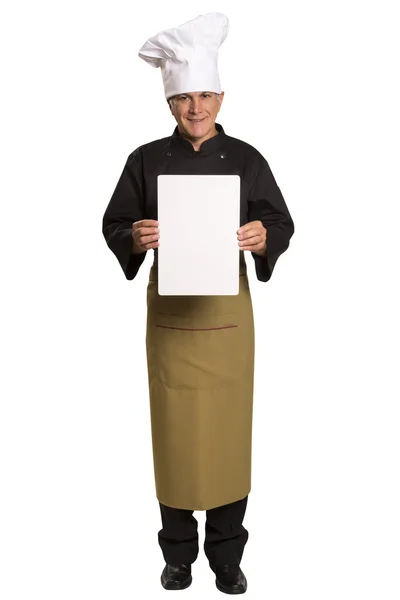 Mature man chef in uniform thumbs up and showing blank visiting card. — Stock Photo, Image