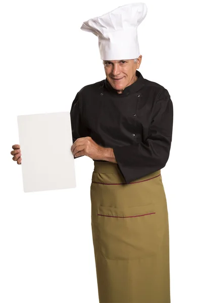 Volwassen man chef-kok in uniforme duimschroef opwaarts en lege visitekaartje weergegeven:. — Stockfoto