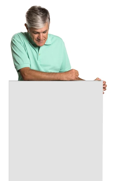 Portrait of a mature man holding a blank panel. — Stock Photo, Image