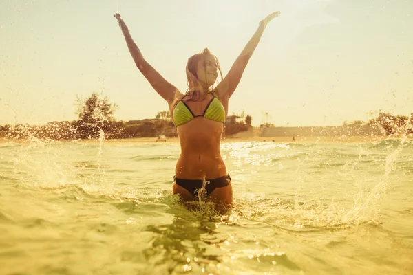 Sexy bikini girl swim sea waves splash vintage tone — Stock Photo, Image