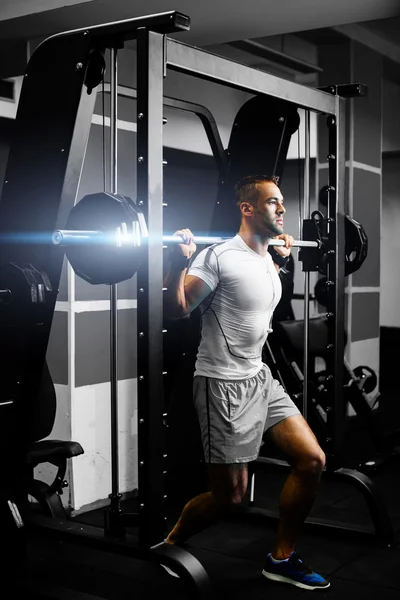 Handsome fitness man weightlifting workout in gym — Stock Photo, Image