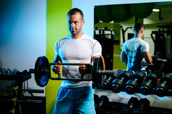 Culturista bombeando manos en el gimnasio — Foto de Stock