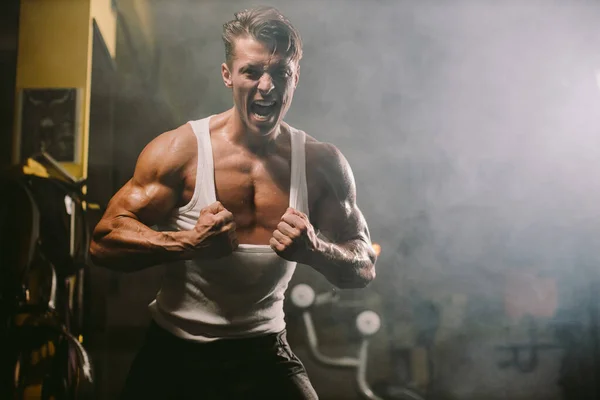 Powerful brutal man tearing shirt — Stock Photo, Image