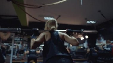 sportive woman doing squats exercises workout group