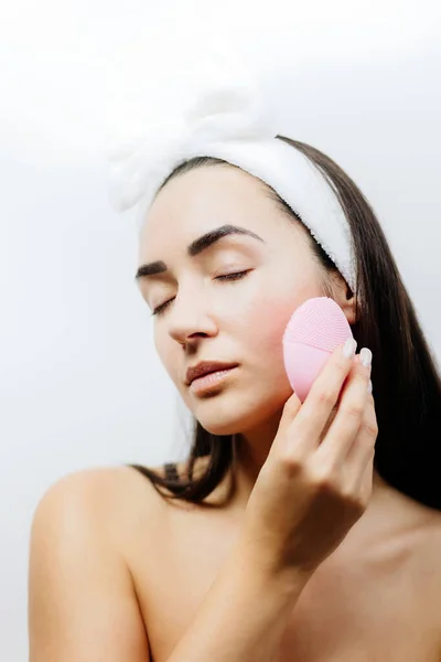 Donna felice utilizzando spazzola detergente elettrica per la pulizia profonda del viso — Foto Stock
