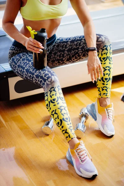 Torso of slim attractive female with protein shake in sportswear — Stock Photo, Image