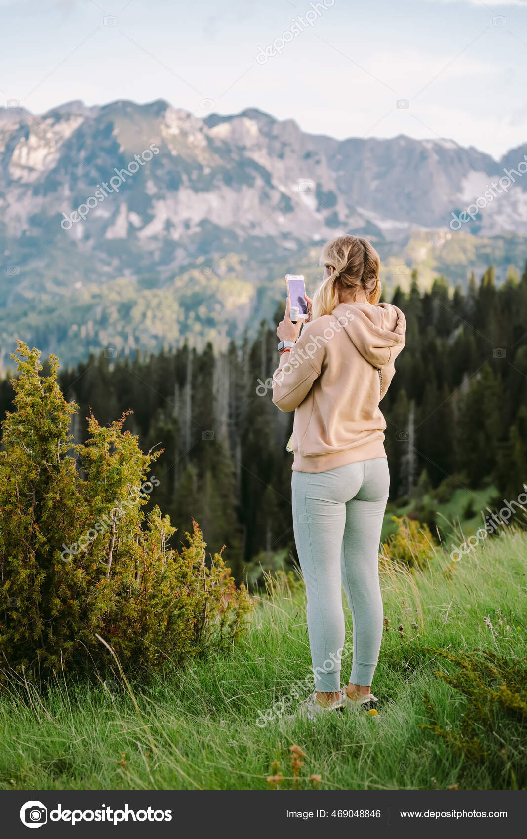 Hipster girl is shooting video of beautiful landscape on smartphone Stock  Photo by ©shevtsovy 469048846