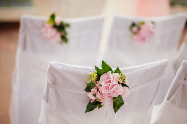 Wedding chair covers with pink flowers — Stock Photo, Image
