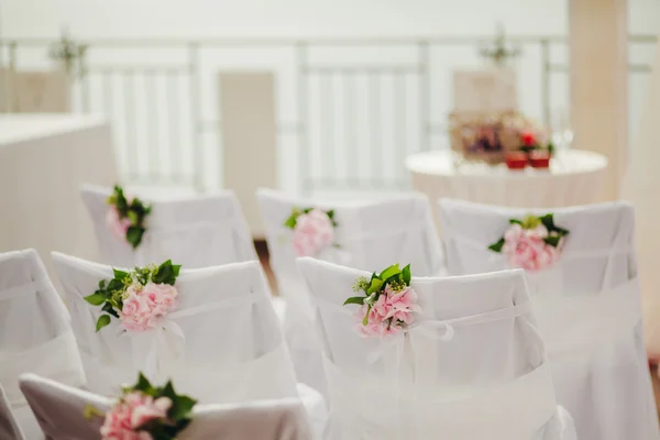 Wedding chair covers with pink flowers — Stock Photo, Image