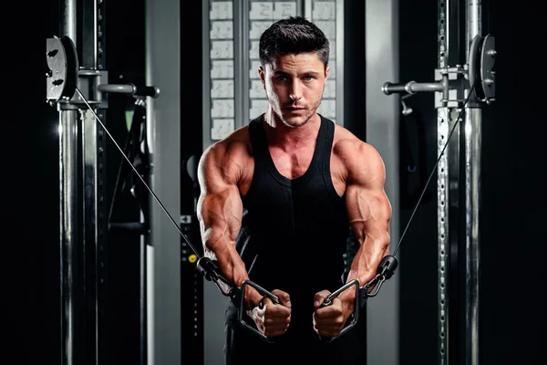 Handsome man work out in gym Stock Picture