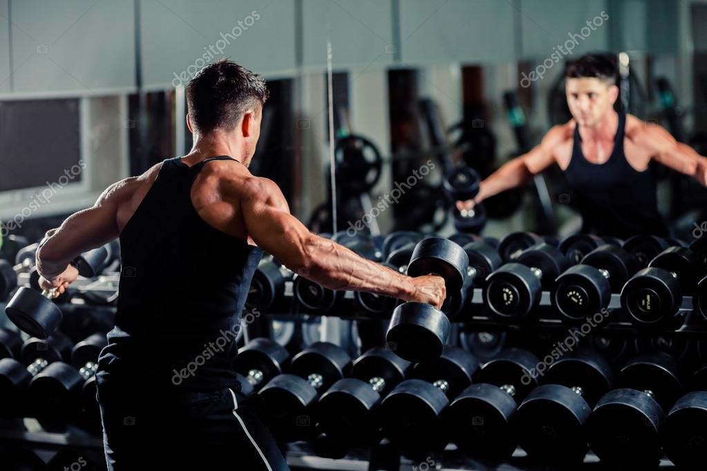 Handsome man workout in gym — Stock Photo © shevtsovy 69413799