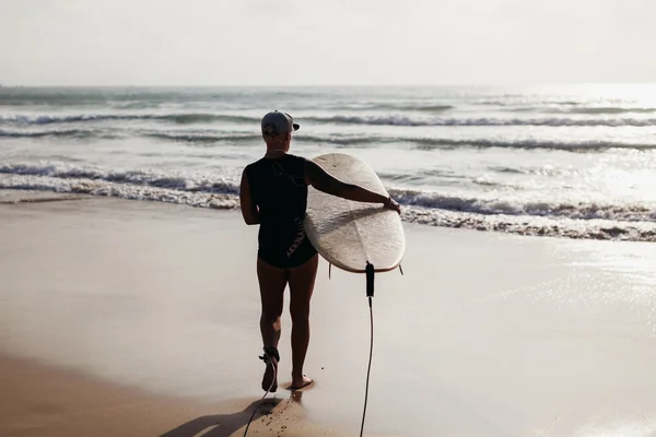 Surfe mulher com prancha de surf vista traseira — Fotografia de Stock