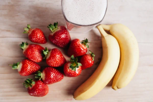 Strawberry banana smoothie fresh blended on wood table — Stock Photo, Image