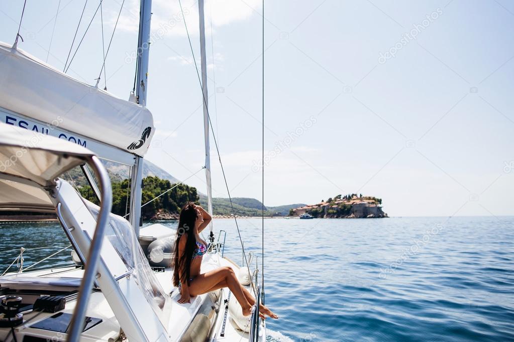 sexy girl in swimwear on yacht in tropics