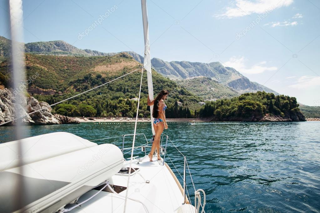 sexy girl in swimwear on yacht in tropics