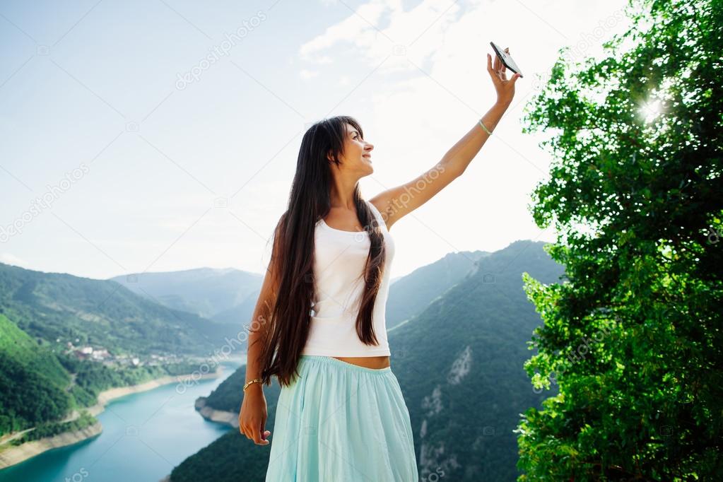 happy girl taking selfie photo on telephone