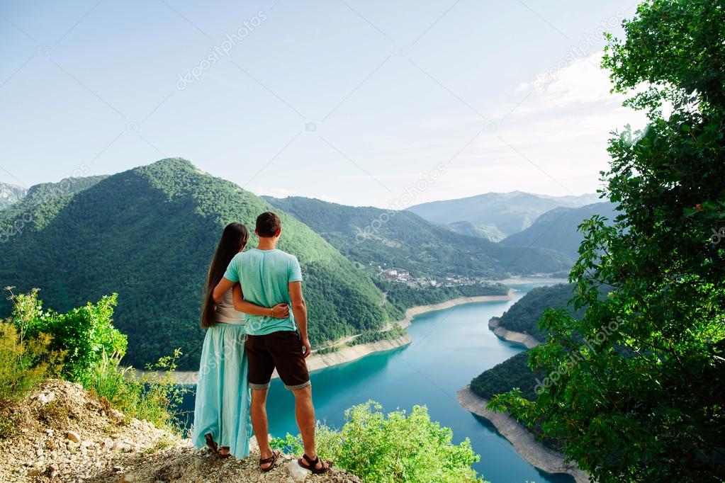 lovely couple relax on peak of mountains
