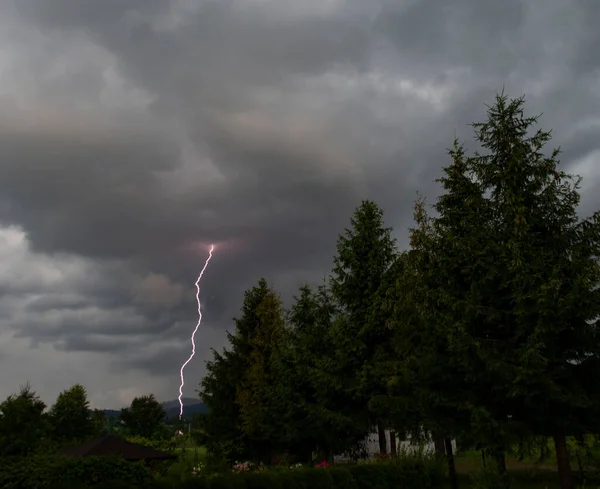 A thunderstorm with lightning and rain over the village will come