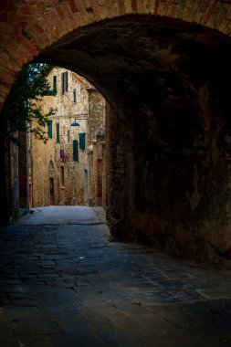 Tuğla kemer, asfalt geçit, tarihi duvarlar, pencere panjurları, köy sokağı, romantik ruh hali..