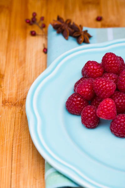 Raspberry on blue plate — Stock Photo, Image