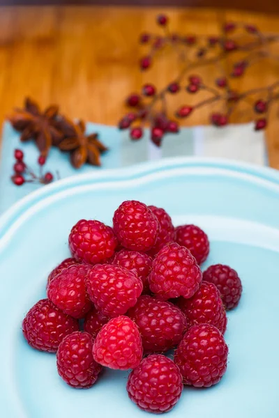 Raspberry on blue plate — Stock Photo, Image