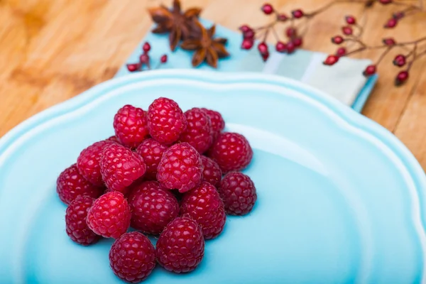 Raspberry on blue plate — Stock Photo, Image