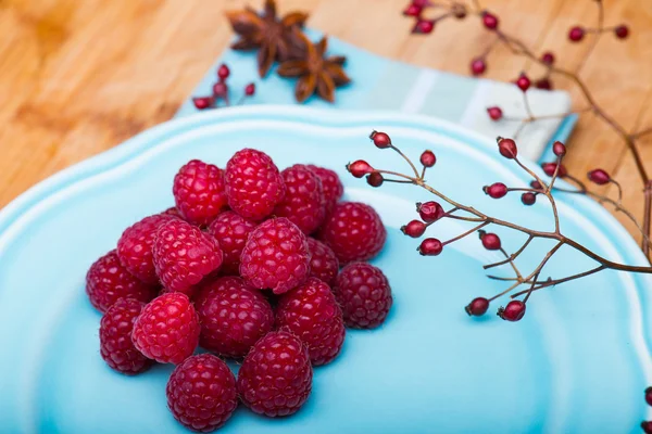 Raspberry on blue plate — Stock Photo, Image