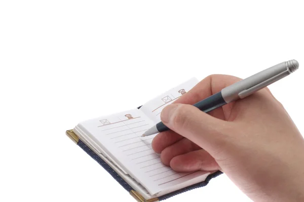 Mão escreve em um caderno — Fotografia de Stock