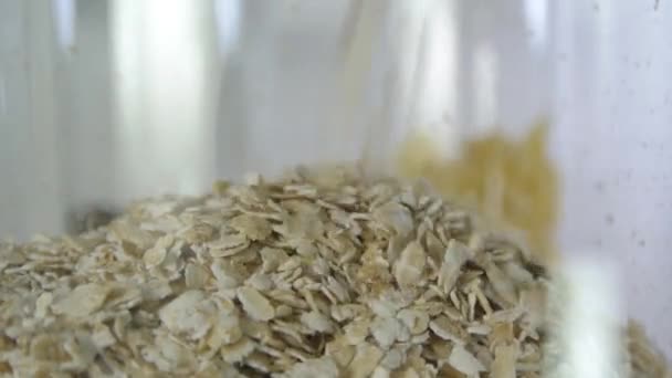 Oatmeal Poured Transparent Glass Jar Fills Shot Close Shallow Depth — Stock Video