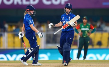 Emma Lamb of England and Heather Knight of England during the ICC Women's World Cup match England Women vs Bangladesh Women at ACA Barsapara Cricket Stadium, Guwahati, Assam/ India, 7th October 2025 