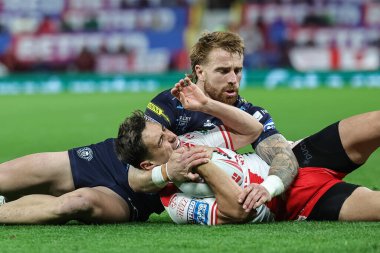 Arthur Mourgue of Hull KR is tackled by Adam Keighran of Wigan Warriors during the 2025 Betfred Super League Grand Final Hull KR v Wigan Warriors at Old Trafford, Manchester, United Kingdom, 11th October 2025