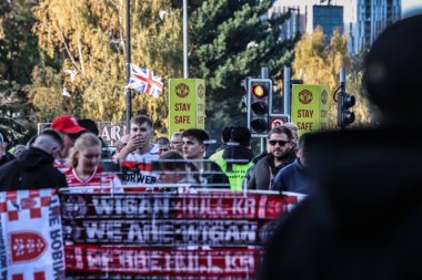 Fans make their way to Old Trafford ahead of the game during the 2025 Betfred Super League Grand Final Hull KR v Wigan Warriors at Old Trafford, Manchester, United Kingdom, 11th October 2025 