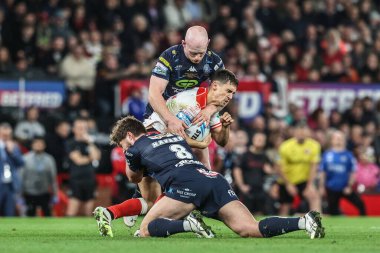 Arthur Mourgue of Hull KR is tackled by Ethan Havard of Wigan Warriors during the 2025 Betfred Super League Grand Final Hull KR v Wigan Warriors at Old Trafford, Manchester, United Kingdom, 11th October 2025 