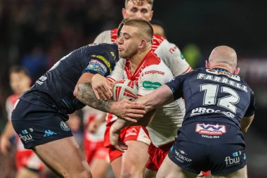 Mikey Lewis of Hull KR is tackled by Liam Farrell of Wigan Warriors during the 2025 Betfred Super League Grand Final Hull KR v Wigan Warriors at Old Trafford, Manchester, United Kingdom, 11th October 2025 