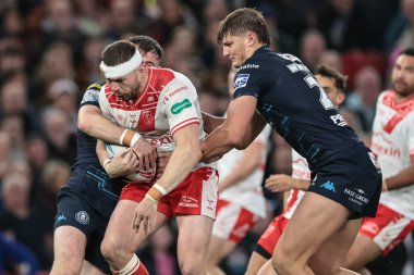 James Batchelor of Hull KR is tackled by Harry Smith of Wigan Warriors during the 2025 Betfred Super League Grand Final Hull KR v Wigan Warriors at Old Trafford, Manchester, United Kingdom, 11th October 2025 