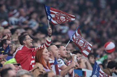 Wigan fans wave flags and sing away during the 2025 Betfred Super League Grand Final Hull KR v Wigan Warriors at Old Trafford, Manchester, United Kingdom, 11th October 2025 