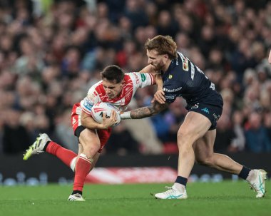 Arthur Mourgue of Hull KR is tackled by Adam Keighran of Wigan Warriors during the 2025 Betfred Super League Grand Final Hull KR v Wigan Warriors at Old Trafford, Manchester, United Kingdom, 11th October 2025 