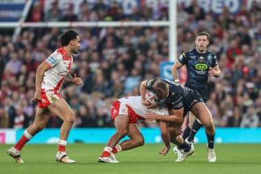 Harvey Makin of Wigan Warriors is tackled during the 2025 Betfred Super League Grand Final Hull KR v Wigan Warriors at Old Trafford, Manchester, United Kingdom, 11th October 2025 