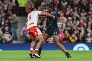 Peta Hiku of Hull KR and Junior Nsemba of Wigan Warriors battle for the ball during the 2025 Betfred Super League Grand Final Hull KR v Wigan Warriors at Old Trafford, Manchester, United Kingdom, 11th October 2025