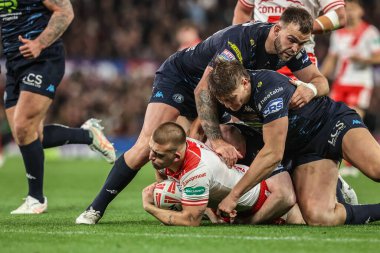 Mikey Lewis of Hull KR is tackled by Liam Farrell of Wigan Warriors during the 2025 Betfred Super League Grand Final Hull KR v Wigan Warriors at Old Trafford, Manchester, United Kingdom, 11th October 2025