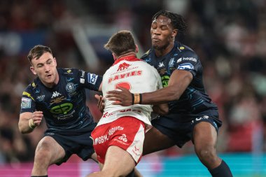 Tom Davies of Hull KR is tackled by Junior Nsemba of Wigan Warriors during the 2025 Betfred Super League Grand Final Hull KR v Wigan Warriors at Old Trafford, Manchester, United Kingdom, 11th October 2025