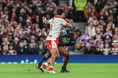 Junior Nsemba of Wigan Warriors evades a tackle form Peta Hiku of Hull KR during the 2025 Betfred Super League Grand Final Hull KR v Wigan Warriors at Old Trafford, Manchester, United Kingdom, 11th October 2025 
