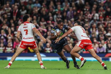Junior Nsemba of Wigan Warriors evades a tackle form Peta Hiku of Hull KR during the 2025 Betfred Super League Grand Final Hull KR v Wigan Warriors at Old Trafford, Manchester, United Kingdom, 11th October 2025 