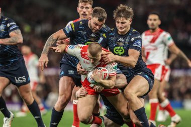 Mikey Lewis of Hull KR is tackled by Liam Farrell of Wigan Warriors during the 2025 Betfred Super League Grand Final Hull KR v Wigan Warriors at Old Trafford, Manchester, United Kingdom, 11th October 2025