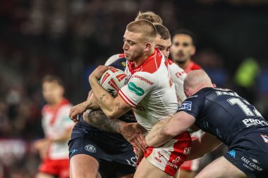 Mikey Lewis of Hull KR is tackled by Liam Farrell of Wigan Warriors during the 2025 Betfred Super League Grand Final Hull KR v Wigan Warriors at Old Trafford, Manchester, United Kingdom, 11th October 2025 