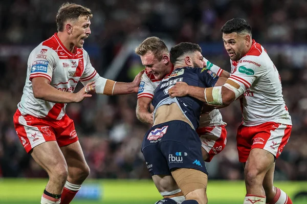 Abbas Miski of Wigan Warriors is tackled by Jez Litten of Hull KR and Rhyse Martin of Hull KR during the 2025 Betfred Super League Grand Final Hull KR v Wigan Warriors at Old Trafford, Manchester, United Kingdom, 11th October 2025 