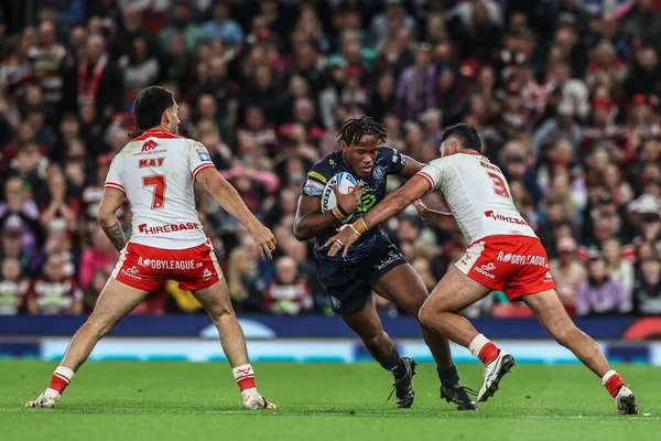Junior Nsemba of Wigan Warriors evades a tackle form Peta Hiku of Hull KR during the 2025 Betfred Super League Grand Final Hull KR v Wigan Warriors at Old Trafford, Manchester, United Kingdom, 11th October 2025 