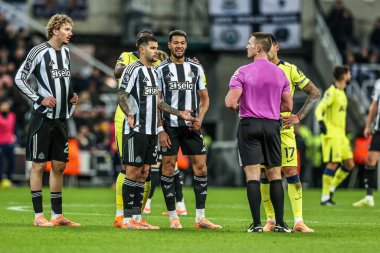Players surround referee Thomas Bramall as VAR check for a penalty during the Premier League match Newcastle United vs Tottenham Hotspur at St. James's Park, Newcastle, United Kingdom, 2nd December 2025 