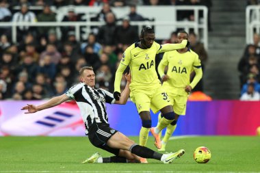 Randal Kolo Muani of Tottenham Hotspur is tackled by Dan Burn of Newcastle United during the Premier League match Newcastle United vs Tottenham Hotspur at St. James's Park, Newcastle, United Kingdom, 2nd December 2025 